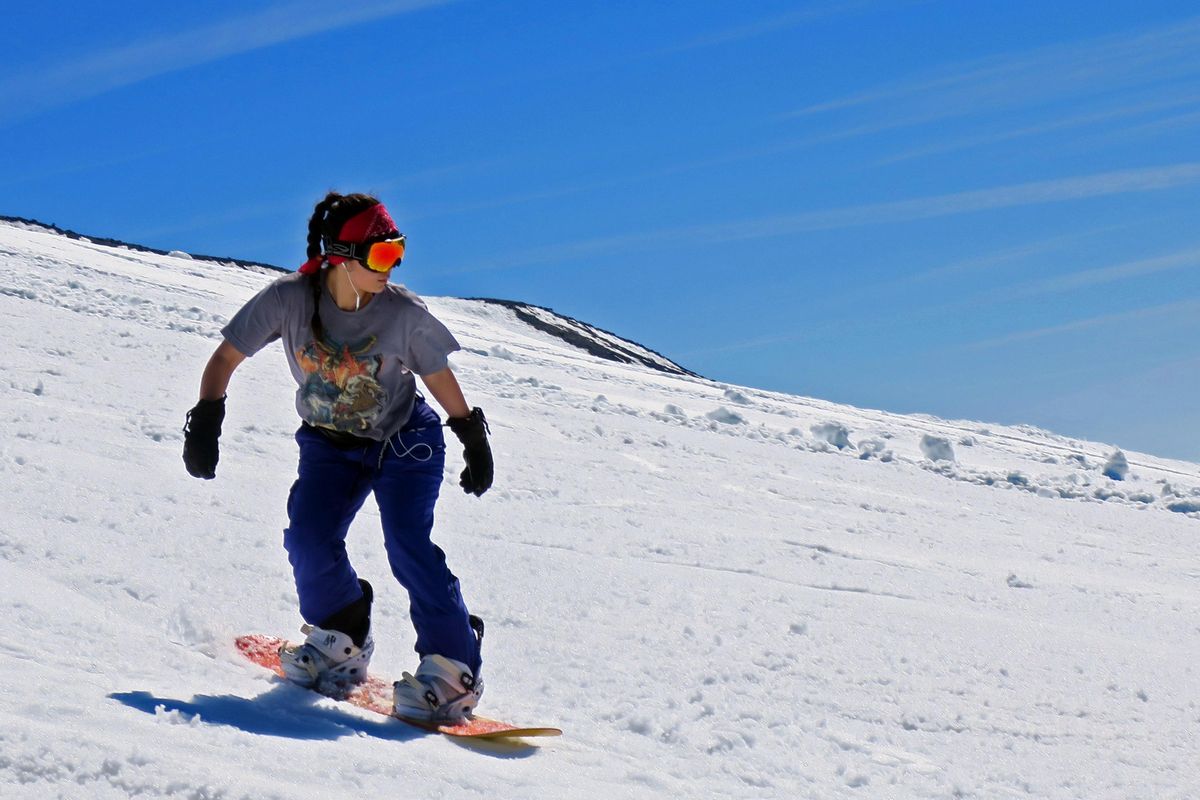 A snowboarder shreds soft snow near the top of Palmer Snowfield on Mount Hood. (John  Nelson / The Spokesman-Review)
