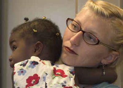 
Foster parent Eva Thibaudeau holds her adopted daughter Maya Rodriguez- Thibaudeau during a news conference held Wednesday in Austin, Texas, to state opposition to proposed legislation that could make Texas the only state to bar gays from becoming foster parents. Thibaudeau, a social worker, said she and her partner of eight years have adopted four children and have served as foster parents to 75. 
 (Associated Press / The Spokesman-Review)