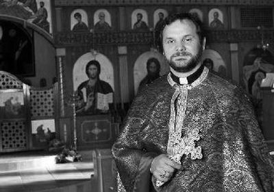 
The Rev. John Dixon is dressed in the traditional vestments he wears during services at Holy Spirit Antiochian Orthodox church in Huntington, W.Va.   Dixon is surrounded by the icons and artwork that adorn most Orthodox churches
 (Associated Press photos / The Spokesman-Review)