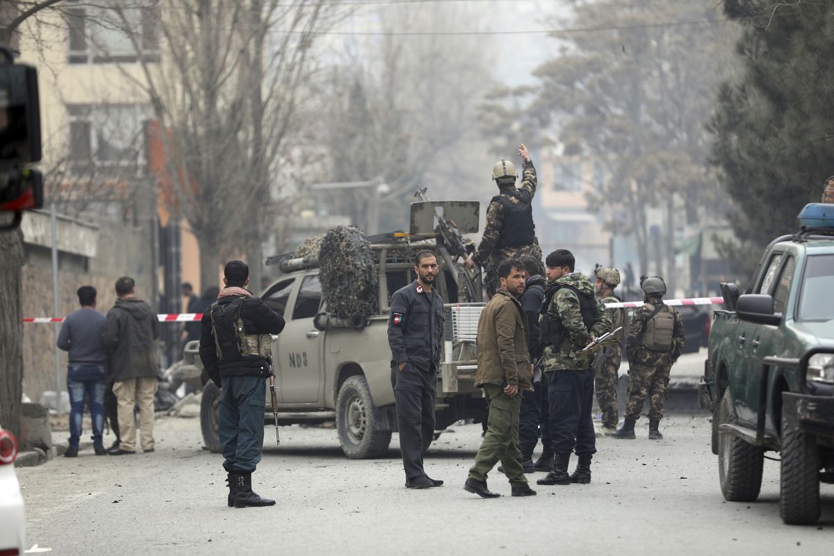 Security personnel inspect the site of a bomb attack in Kabul, Afghanistan, Saturday, Feb. 20, 2021. Three separate explosions in the capital Kabul on Saturday killed and wounded numerous people an Afghan official said.  (Rahmat Gul)