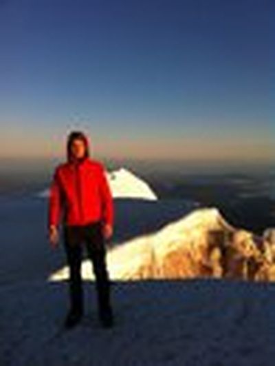 Robert Millsap stands on the summit of Mt. Hood at sunrise after a before-dawn ascent. (photo courtesy of Cheryl-Anne Millsap)