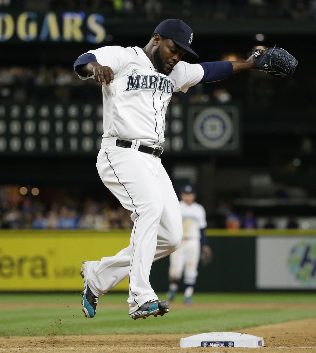 Seattle closer Fernando Rodney jumps on first base with the final out. (Associated Press)