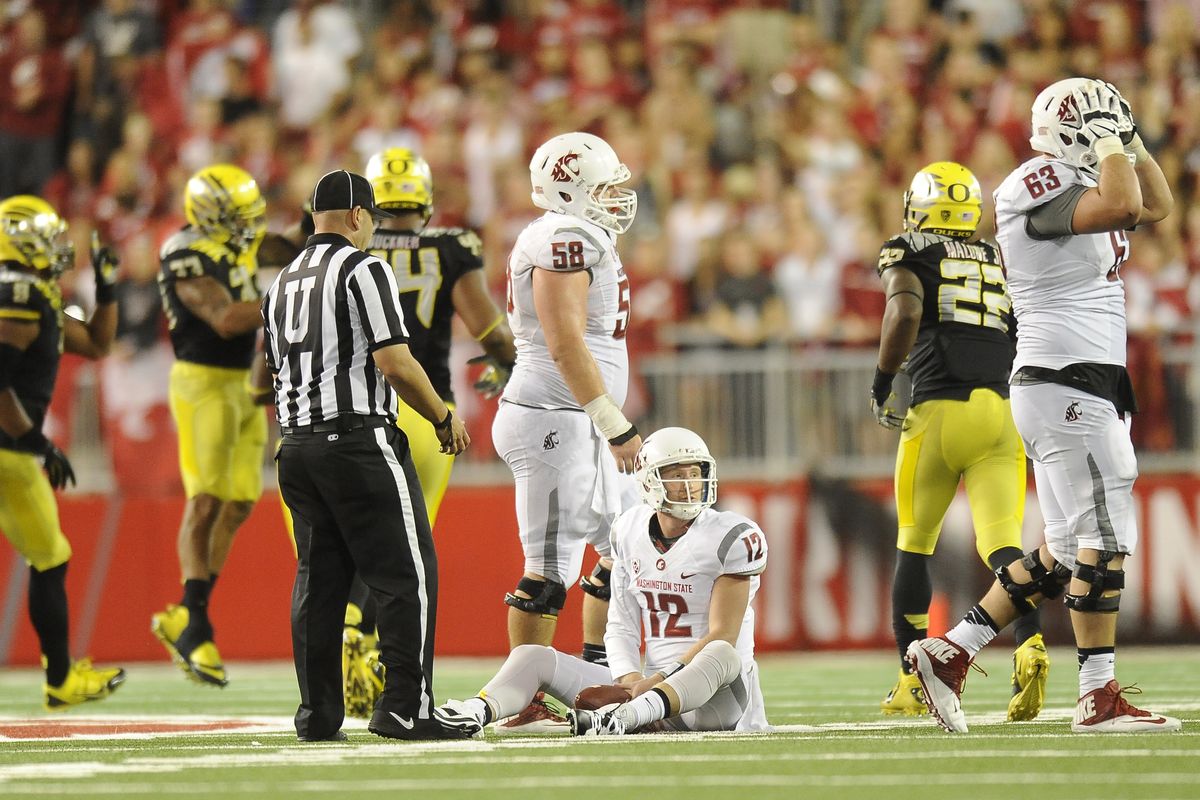 WSU quarterback Connor Halliday (12) reacts after he was sacked on fourth down during WSU’s final drive against Oregon during the second half. (Tyler Tjomsland)