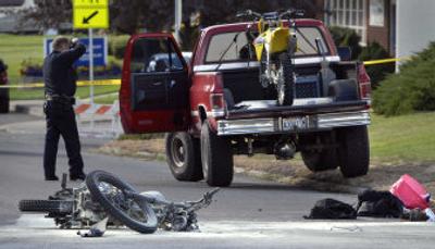 
Spokane police investigate an accident between a pickup truck and a motorcycle near the corner of Garland Avenue and Cannon Street on Thursday. Police said the motorcycle caught fire. 
 (Dan Pelle / The Spokesman-Review)