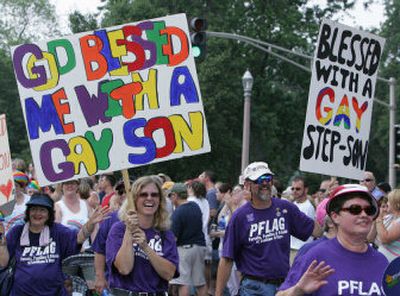 
Members of Parents, Families & Friends of Lesbians and Gays (PFLAG) march with their signs in St. Louis' PrideFest parade on Sunday.  
 (Associated Press / The Spokesman-Review)