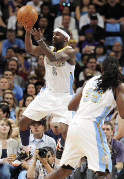 Nuggets guard Ty Lawson pulls in the ball as forward Kenneth Faried looks on in host Denver’s win against the Lakers. (Associated Press)