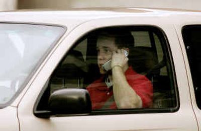 
A motorist talks on a cell phone while driving Tuesday in Salt Lake City. 
 (Associated Press / The Spokesman-Review)