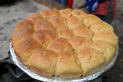 
A picture perfect round of biscuits cools after coming out of a dutch oven.
 (JESSE TINSLEY photos / The Spokesman-Review)