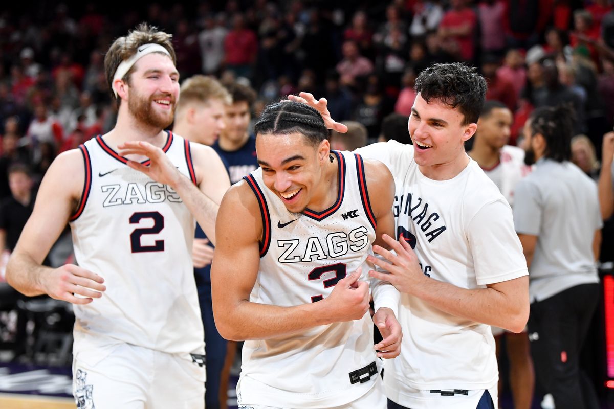 Gonzaga Bulldogs guard Andrew Nembhard (3) celebrates with forward Drew Timme (2) and guard Matthew Lang (23) after they won their Jerry Colangelo Classic matchup against Texas Tech on Saturday, Dec 18, 2021, at Footprint Center in Phoenix, Ariz. Gonzaga won the game 69-55.  (Tyler Tjomsland/The Spokesman-Review)