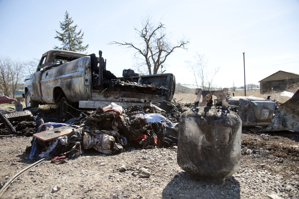 A propane tank sits outside a burned-out pickup truck after an explosion, April, 10, 2014, in northeast Spokane, Wash.  The early-morning blast rocked the neighborhood and broke windows at the corner of Ferrell and Broad. (Dan Pelle / The Spokesman-Review)
