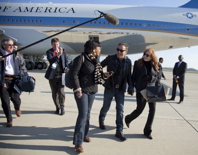 Bruce Springsteen and his wife wife Patti Scialfa are followed by press pool media members as they deplane off the back of Air Force One at Rickenbacker International Airport in Columbus, Ohio, Monday, Nov. 5, 2012, as they traveled with President Barack Obama to a campaign event at Nationwide Arena. (Carolyn Kaster / Associated Press)