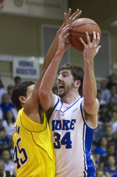 Michigan’s Colton Christian puts the heavy defense on Duke forward Ryan Kelly, who scored 17 in the Blue Devils’ win Tuesday. (Associated Press)