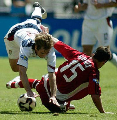 
Steve Raltson of the U.S. gets tripped up while pursuing a ball in the Americans' 2-0 win.
 (Associated Press / The Spokesman-Review)