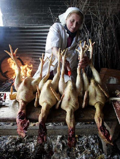 
A worker cleans chickens in a farm in Benevento, near Naples, Italy, on Monday. Poultry for sale in Italy will carry labels indicating its origin. 
 (Associated Press / The Spokesman-Review)