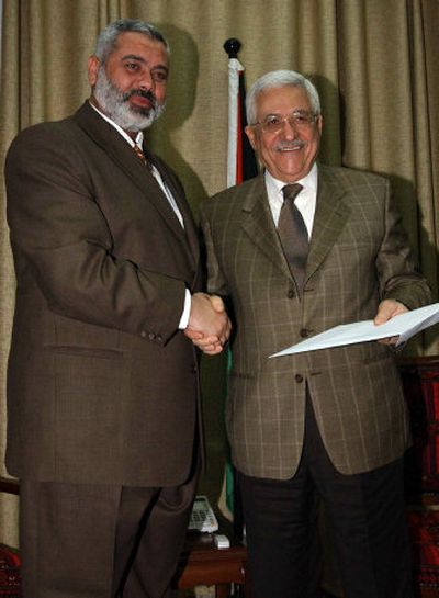 
Incoming Palestinian Prime Minister Ismail Haniyeh, left, meets with President Mahmoud Abbas to present his new Cabinet in Gaza City on Sunday.
 (Associated Press / The Spokesman-Review)