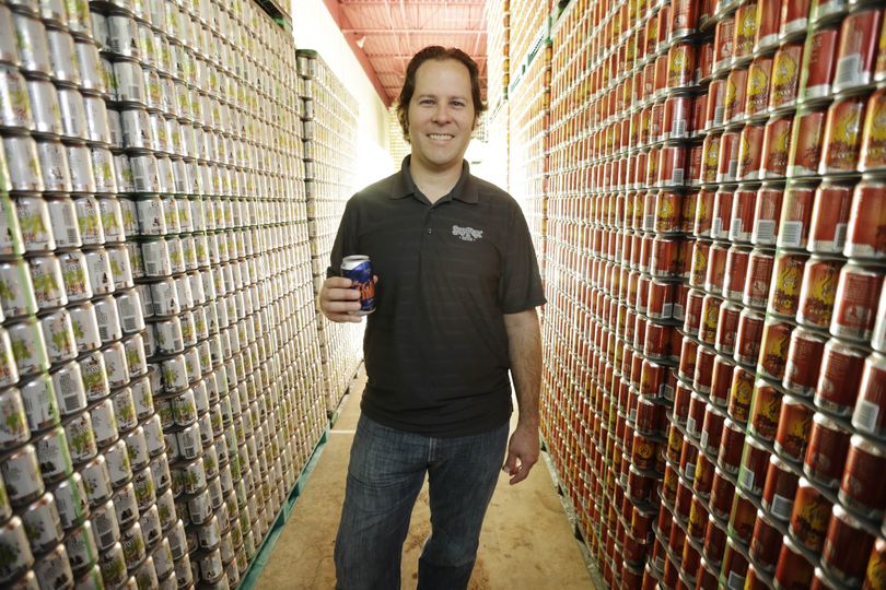 Brewmaster Brian O’Reilly holds a can of Helles Golden Lager with a 360 Lid as he poses for a portrait at the Sly Fox Brewing Co. in Pottstown, Pa. (Associated Press)