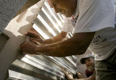 Joe Spalik  puts up hurricane siding on his home on Padre Island,Texas, on Wednesday in preparation for Hurricane Ike.  (Associated Press / The Spokesman-Review)