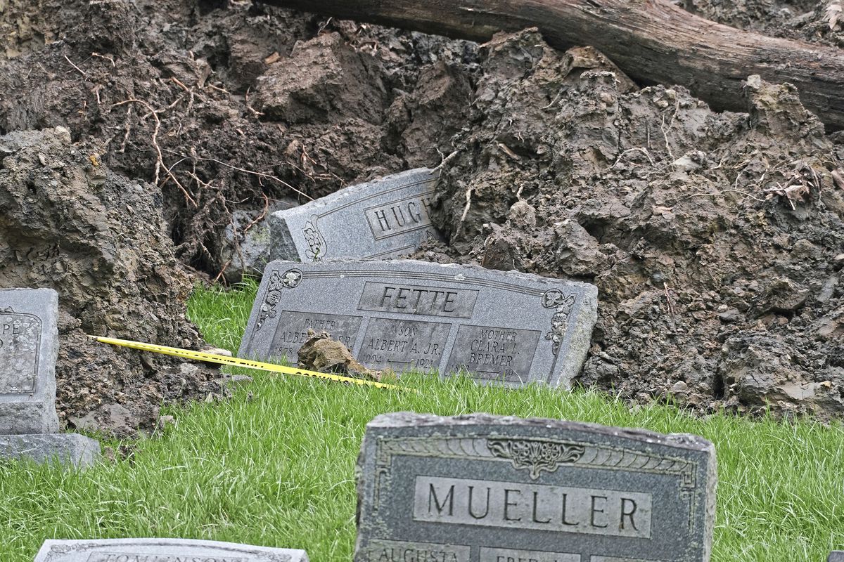 Gravestones moved by a landslide sit on the edge of a debris field in the Wheeling Mt. Zion Cemetery Saturday, April 6, 2024, in Wheeling, West Virginia. The slide caused by this week