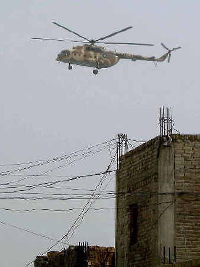 
A Pakistani army helicopter patrols on the outskirts of Wana, the capital of Pakistan's tribal area of South Waziristan along the border with Afghanistan. 
 (Associated Press / The Spokesman-Review)