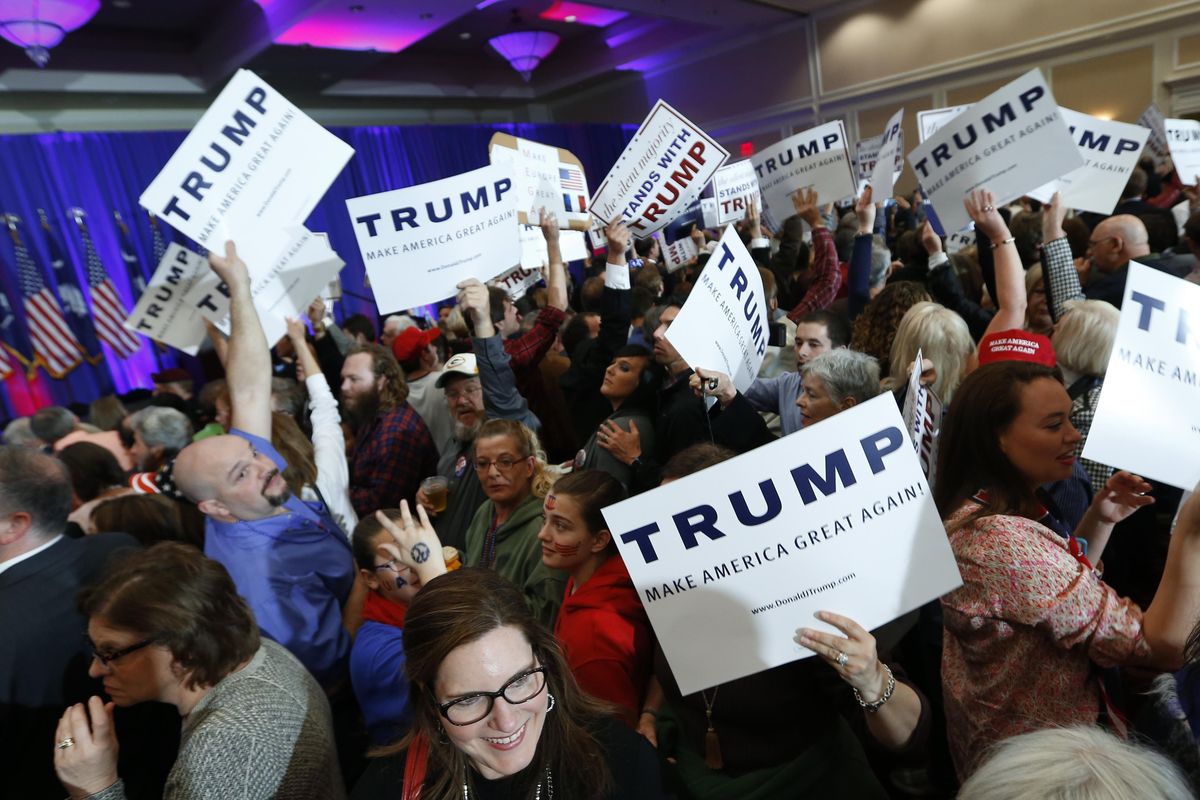 Supporters for Republican presidential candidate Donald Trump hold signs during a South Carolina Republican primary night event Saturday, Feb. 20, 2016, in Spartanburg, S.C. (Paul Sancya / Associated Press)