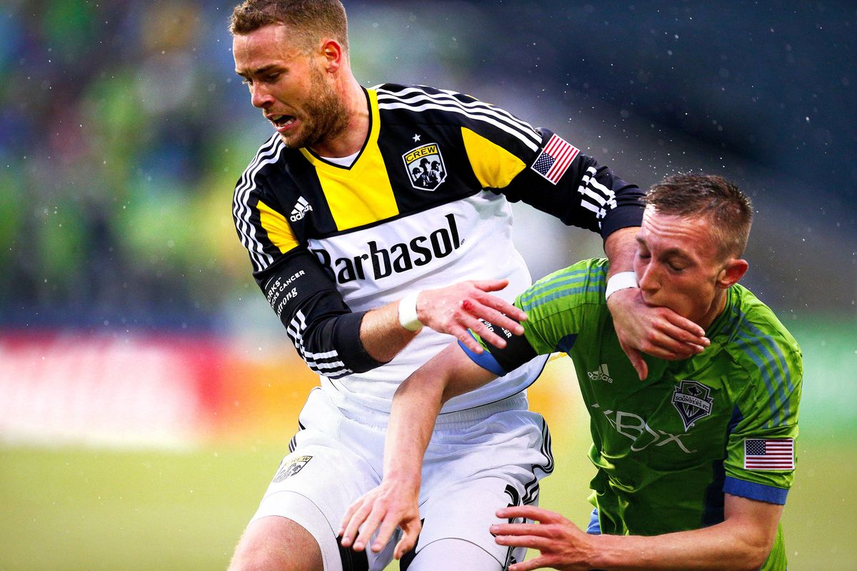 Sounders’ Dylan Remick, right, gets blocked by Columbus’ Josh Williams during first-half action in Seattle.