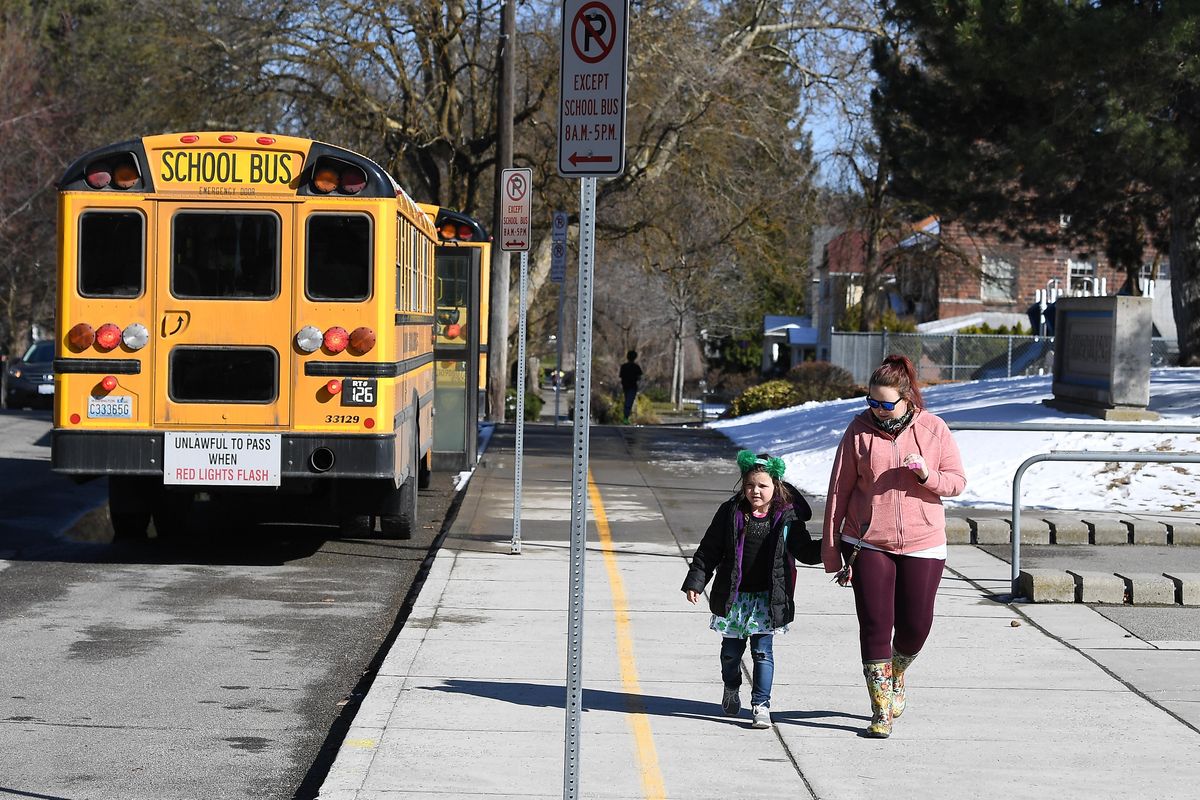 Samantha Green, right, walks her daughter Madison Green, a five-year-old kindergartner to their car as school ends for the day on Monday, March 16, 2020, at Roosevelt Elementary in Spokane, Wash. Officials say school will be closed for at least six weeks to help curb the spread of coronavirus. (Tyler Tjomsland / The Spokesman-Review)