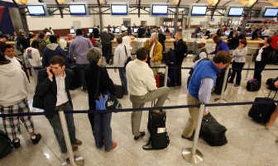 
Travelers wait in line at the Delta Air Lines ticket counter at Hartsfield-Jackson International Airport in Atlanta. Delta canceled hundreds of flights Thursday as the airline continued its inspections of wiring bundles on some of its planes. Associated Press photos
 (Associated Press photos / The Spokesman-Review)