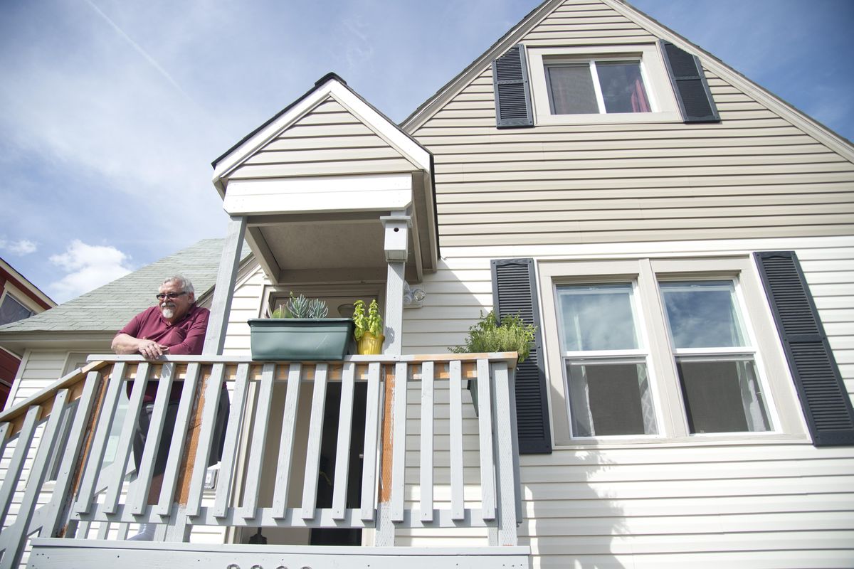 John Welch, a retiree from Whidbey Island, stands on the porch of his home on College Ave., Thursday, Sept. 2, 2016. He now owns the home in West Central that was notorious for homeless squatters and drug dealing. It was taken from the former owner and refurbished and Welch purchased it earlier this year. (Jesse Tinsley / The Spokesman-Review)