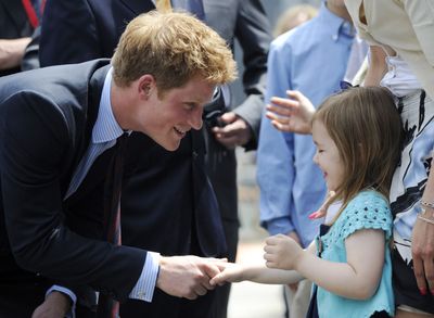 Britain’s Prince Harry  greets Madison Murphy,  4, and her mother, Monica Iken, Friday at the site of the Sept. 11, 2001, World Trade Center terrorist attack. Monica’s husband, Michael, was killed.  (Associated Press / The Spokesman-Review)