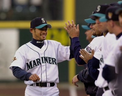 Seattle Mariners' Ichiro Suzuki is greeted by his teammates as he is introduced before the game against the Oakland Athletics on opening night, Monday, April 2, 2001, in Seattle, the last season the Mariners made the postseason. (Elaine Thompson / Associated Press)
