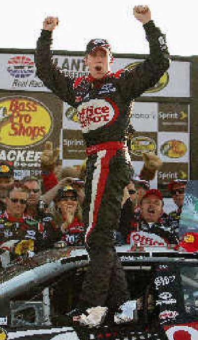 
Carl Edwards pumps his fists before doing his familiar victory backflip.
 (Associated Press / The Spokesman-Review)