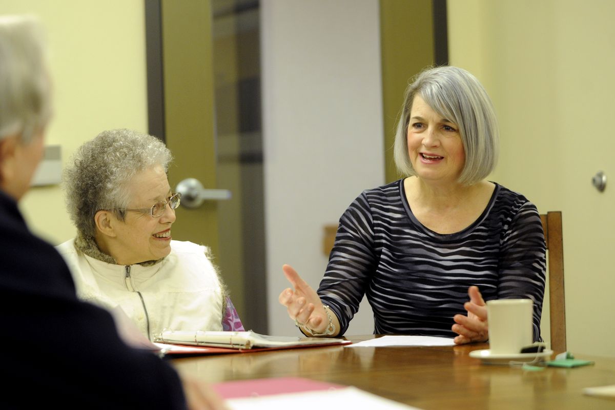 Kathy Bryant, right, a real estate broker specializing in senior housing, sits in a writing group and listens to Mary Lou Stanton, left, and John Rochford, far left, at Moran Vista Senior Living. Bryant is spending one week each month in 12 different Inland Northwest retirement communities in 2011. (Jesse Tinsley)