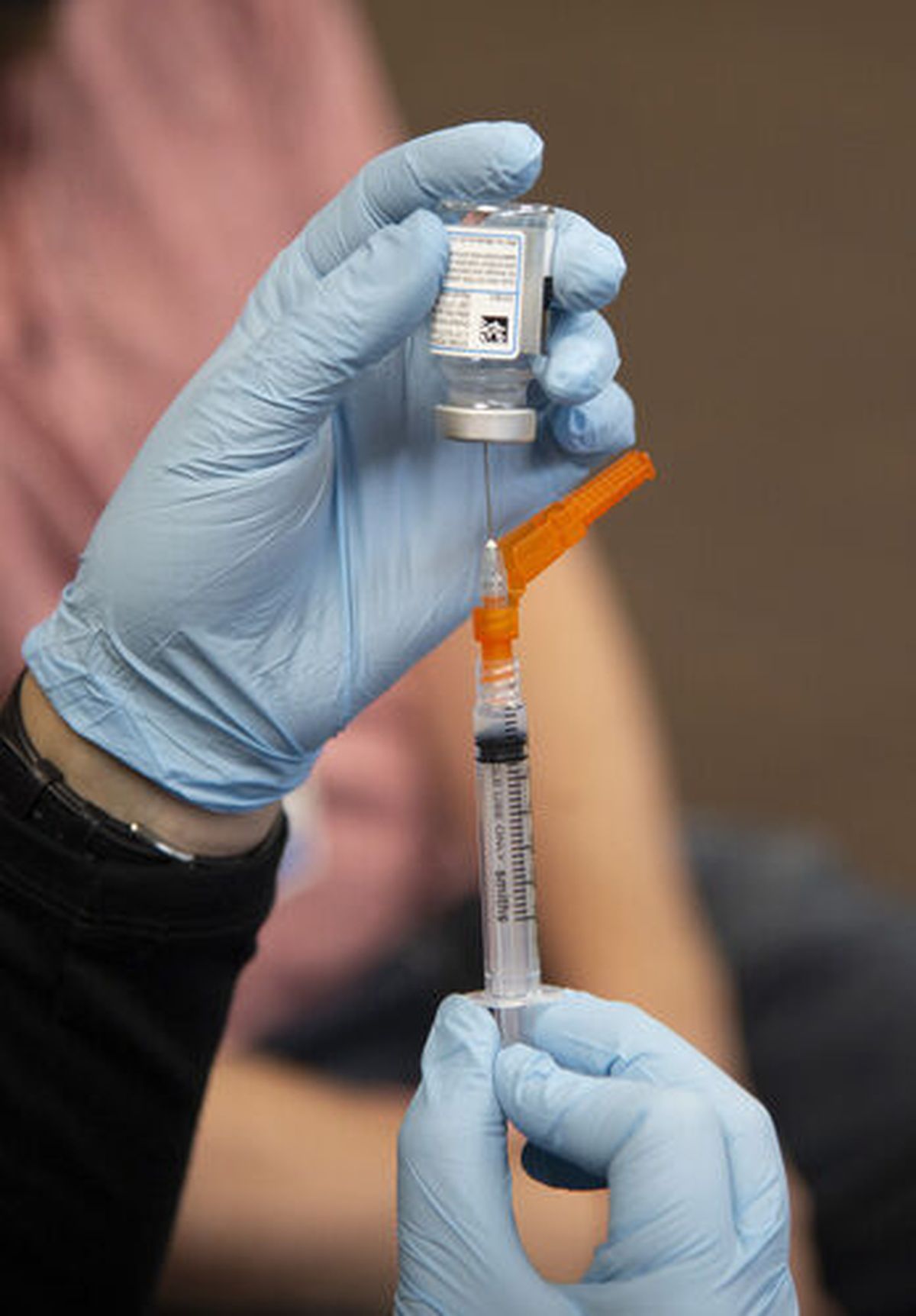 A syringe is prepared with the Moderna COVID-19 vaccine in this photo from earlier this year when school employees were getting vaccinated. The state has released vaccination rate data for school districts.  (Jesse Tinsley/The Spokesman-Review)