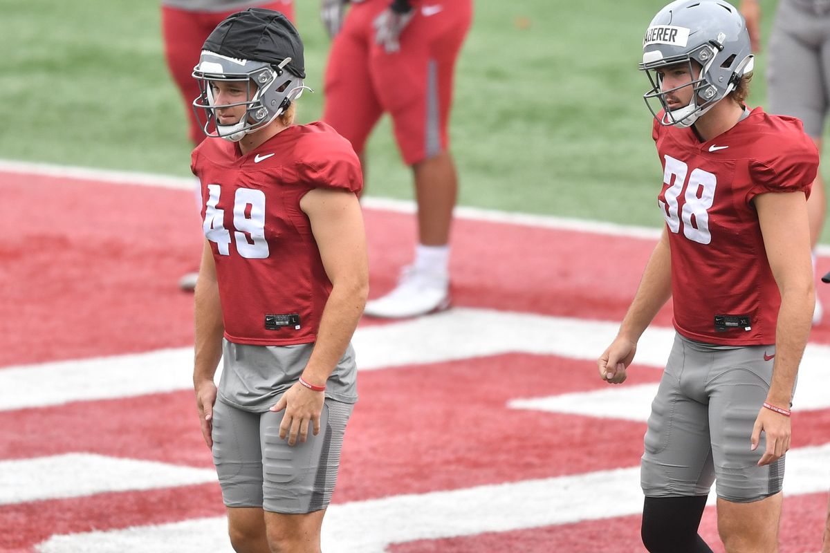 Washington State place-kicker Dean Janikowski, left, and punter Nick Haberer watch the action unfold during a preseason practice Aug. 9 at Rogers Field in Pullman.  (Tyler Tjomsland/The Spokesman-Review)