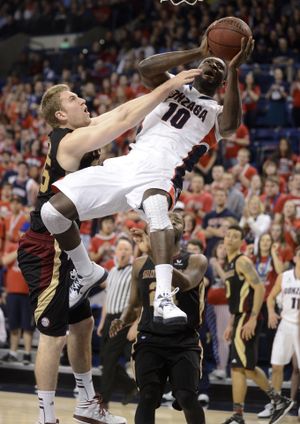 Santa Clara's John McArthur left, is called for a flagrant foul as Gonzaga's Guy Landry Edi (10) heads to the basket in the second half of their men's college basketball game, Wednesday, Feb. 20, 2013, in the McCarthey Athletic Center. (Colin Mulvany / The Spokesman-Review)