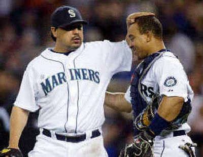 
Mariners closer Eddie Guardado, left, and catcher Miguel Olivo greet each other after Saturday's 5-3 win. 
 (Associated Press / The Spokesman-Review)