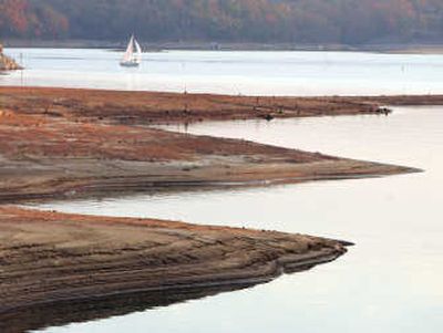 
A sailboat  passes the exposed lake bottom on Lake Lanier in Flowery Branch, Ga., on Sunday. Associated Press
 (Associated Press / The Spokesman-Review)