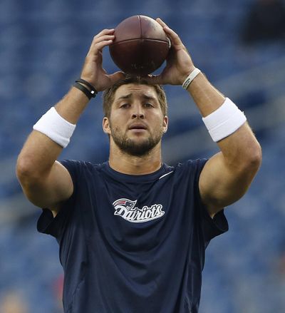 Former Patriots quarterback Tim Tebow plans to work out for major league teams later this month. (Elise Amendola / Associated Press)