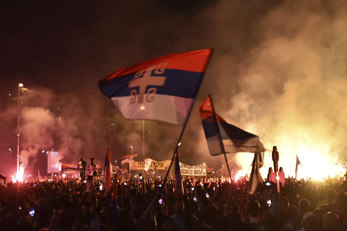 People attend the arrival of the head of the Serbian Orthodox Church, Patriarch Porfirije, in front of the Serbian Orthodox Church of Christ