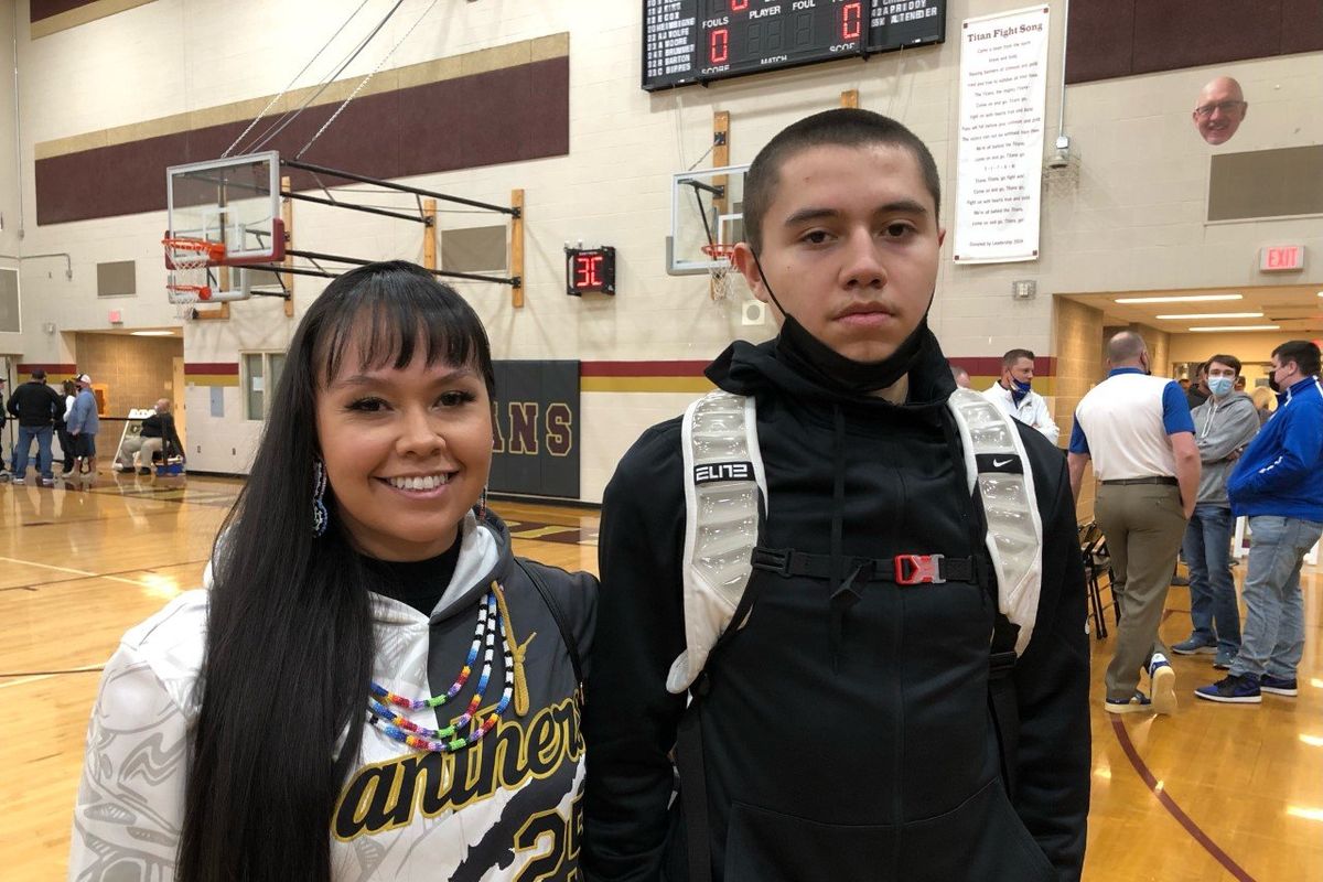 Taunie Cullooyah, left, with son Louis, after the Cusick boys advanced to the state quarterfinals on Feb. 26, 2022 at University HS.  (Dave Nichols/THE SPOKESMAN-REVIEW)