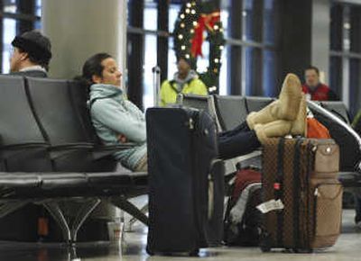 
An airline passenger rests while waiting at Logan International Airport last month in Boston. Associated Press
 (Associated Press / The Spokesman-Review)