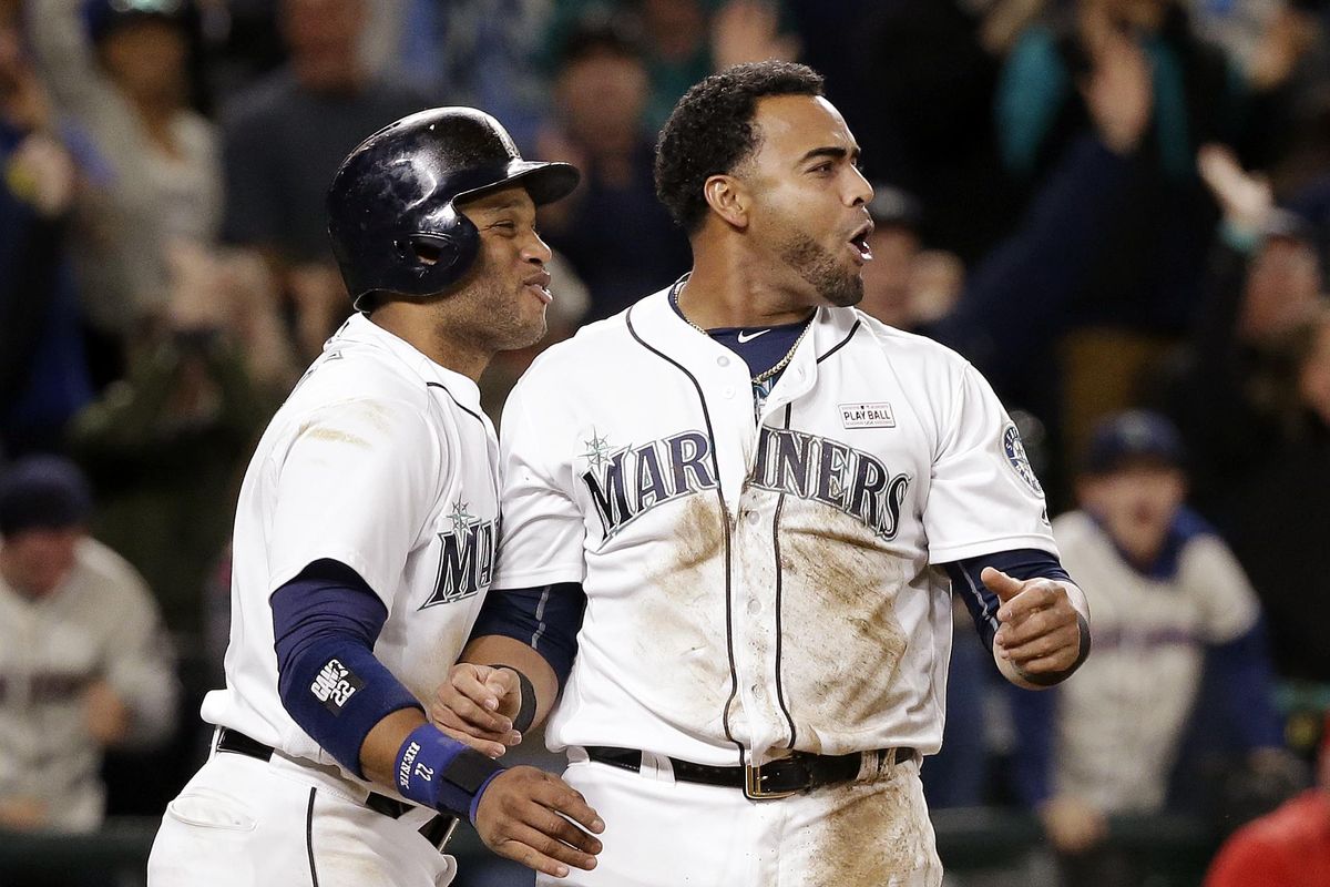 Robinson Cano, left, and Nelson Cruz had big first halves at the plate for Seattle. (Elaine Thompson / Associated Press)