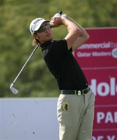 Brett Rumford of Australia takes his shot at the 8th hole while playing the 2nd round of the Qatar Masters at Doha Golf Club on Friday, Jan. 29, 2010.  (Maneesh Bakshi / Associated Press)