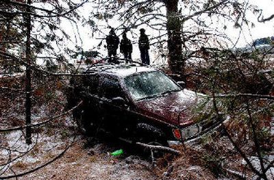 
Icy roads contributed to several accidents on Monday morning, including this Nissan Pathfinder that went over a shallow embankment off of Northwest Blvd., in Coeur d'Alene. A new storm could bring 3 to 5 inches of new snow today.
 (Kathy Plonka / The Spokesman-Review)