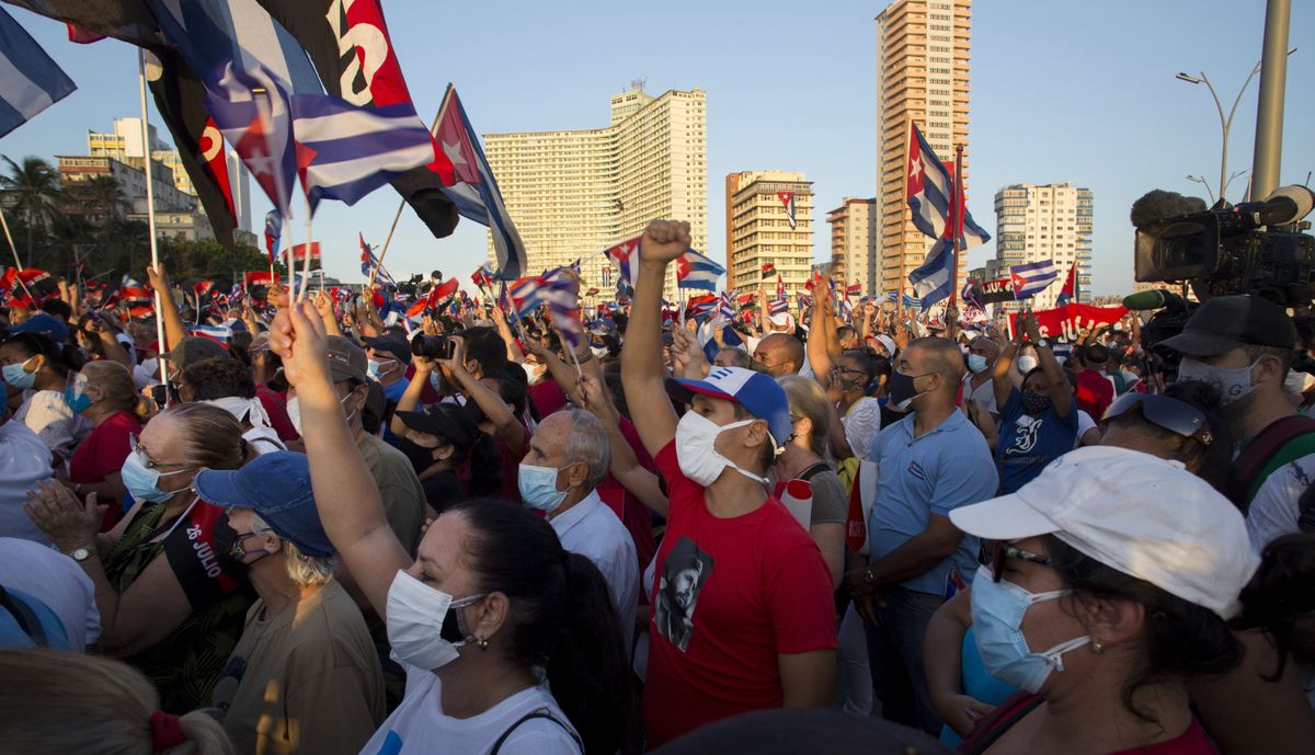 People attend a cultural-political event on the seaside Malecon Avenue with thousands of people in a show of support for the Cuban revolution six days after the uprising of anti-government protesters across the island, in Havana, Cuba, Saturday, July 17, 2021.  (Ismael Francisco)