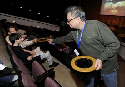 Volunteer Jim Mueller collects donations during service at Waterfront Community Church in Schaumburg, Ill., Dec. 14. Since it started in October, Waterfront has raised about  $11,500 for charity.  (Associated Press / The Spokesman-Review)