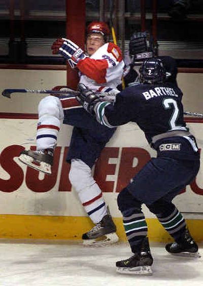 
Spokane's Kyle Howarth is checked into a support by Seattle's Clayton Barthel in the Chiefs' 4 -2 loss at the Arena. 
 (Jed Conklin / The Spokesman-Review)