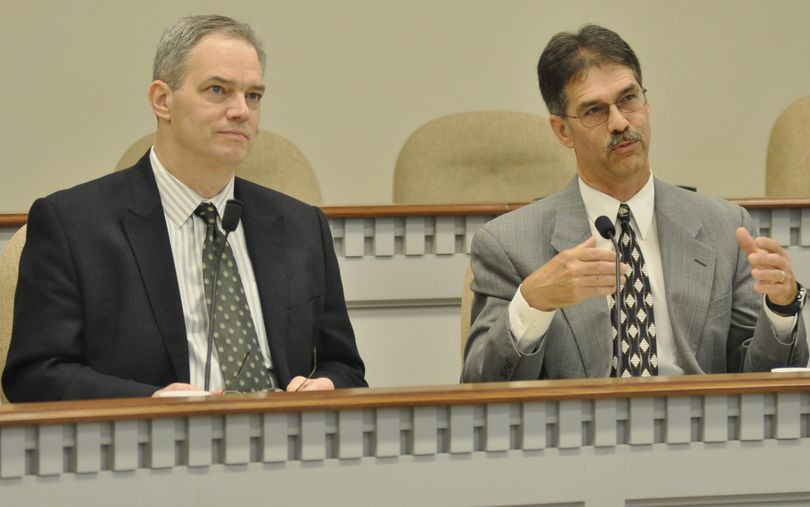 OLYMPIA -- State economist Steve Lerch explains some details of the latest economic forecast as Rep. Ross Hunter, chairman of the House Appropriations Committee looks on in a meeting of the state Economic and Revenue Forecast Council Tuesday (Jim Camden)