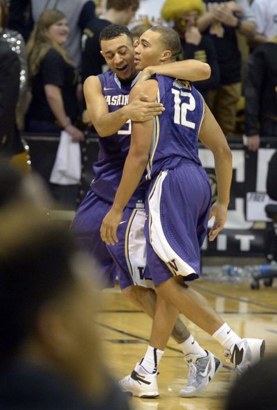 UW’s Nigel Williams-Goss, left, hugs Andrew Andrews after his winning shot. (Associated Press)