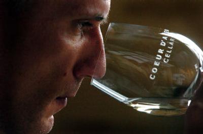 
Winemaker Warren Schutz of Coeur d'Alene Cellars experiences a wine with his nose before tasting it Friday. 
 (The Spokesman-Review)